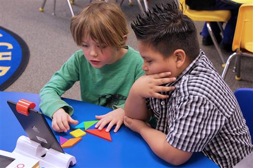 Two students with an iPad 